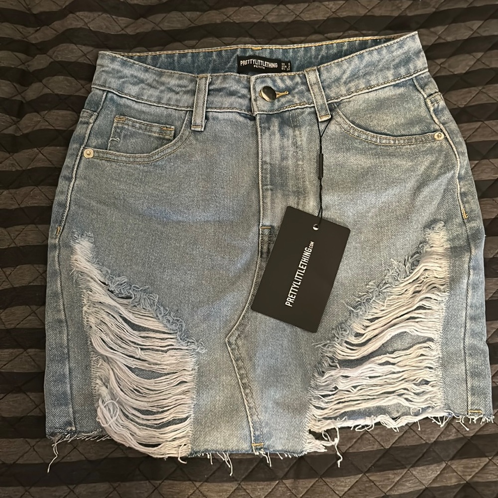Petite light blue wash distressed mini denim skirt